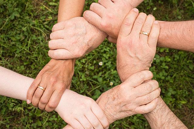 Six individuals linking hands