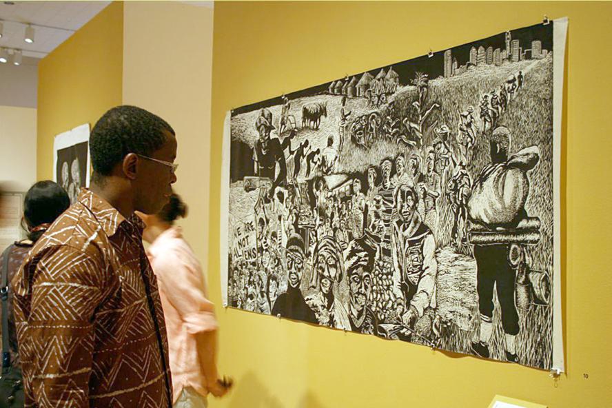 African American man studying artwork at Art Gallery