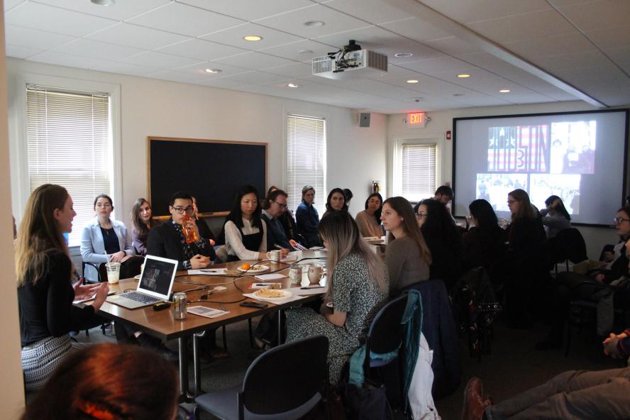 Students at conference table for master's thesis presentation