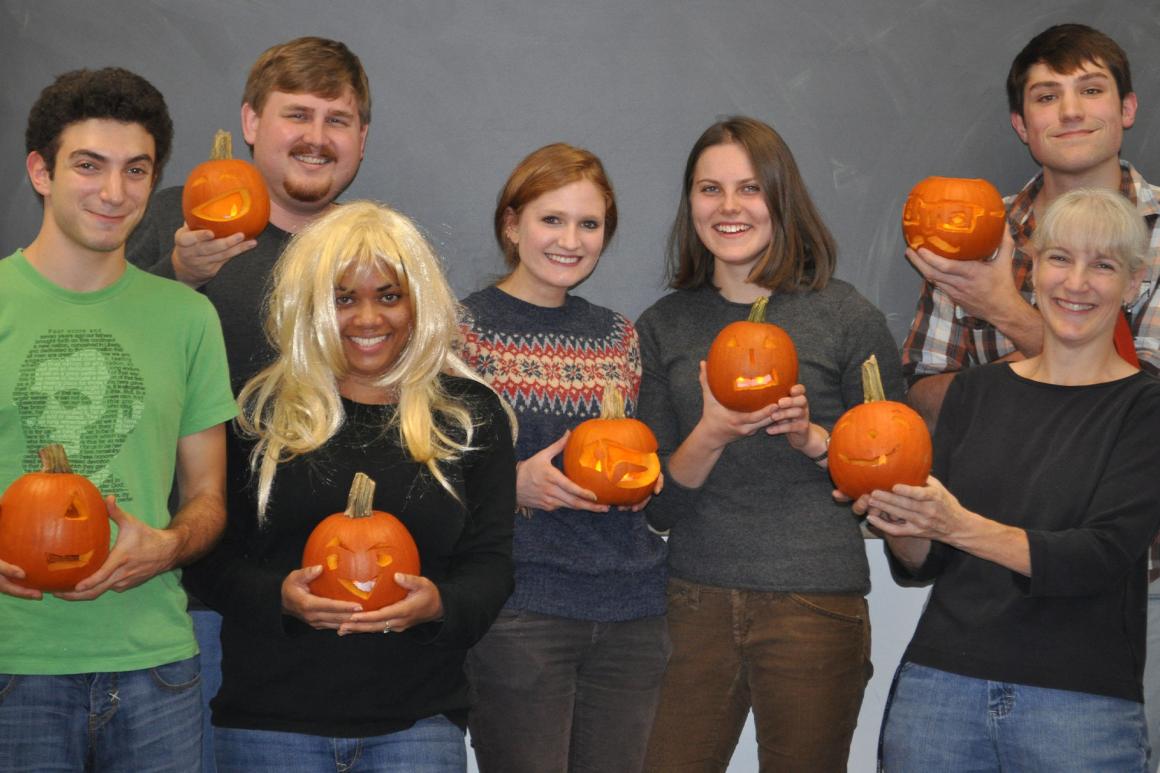 Halloween lab gathering with members holding pumpkins