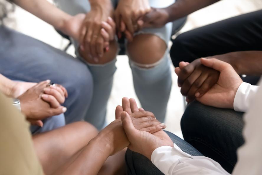 Many hands holding onto each other