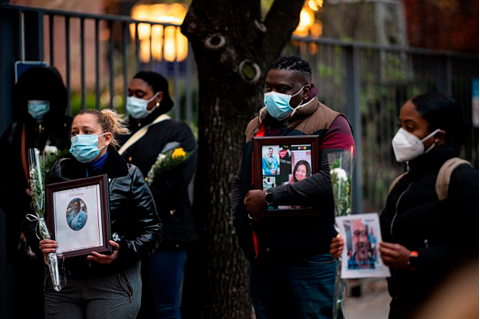 Nurses and healthcare workers remember their colleagues who died of the novel coronavirus during a demonstration outside Mount Sinai Hospital in Manhattan on April 10. Photo: Johannes Eisele/AFP/Getty