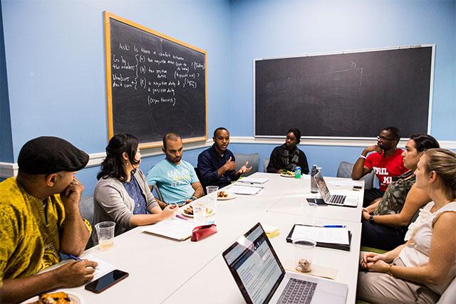 Students sitting around a conference room table at Tufts