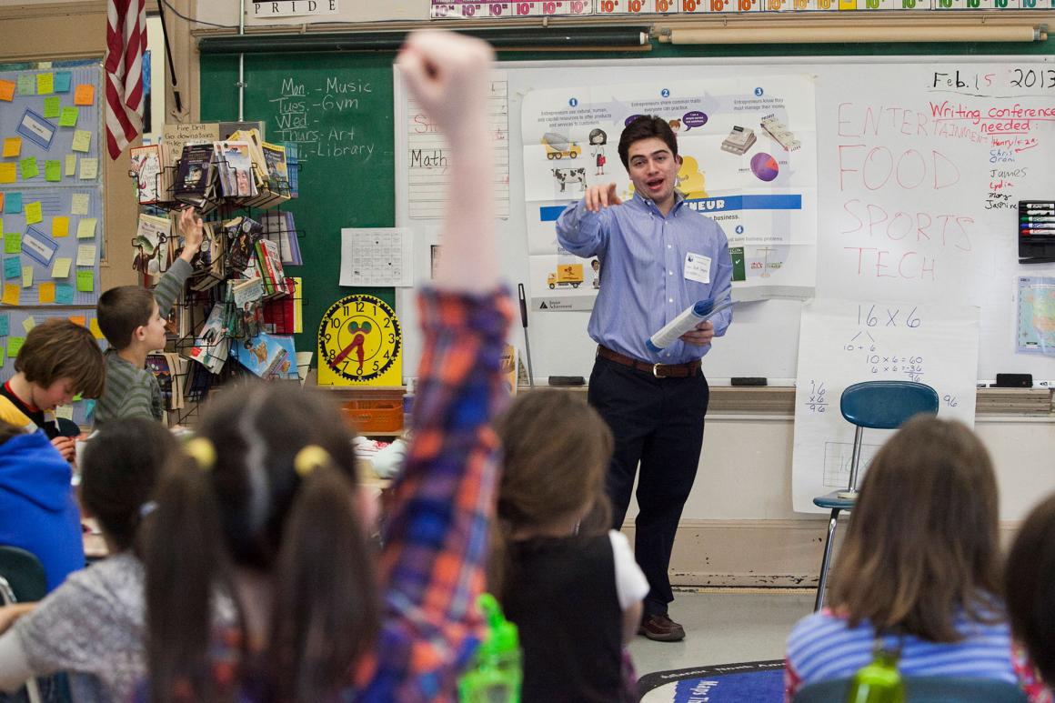 Tufts Economics student visiting an elementary school to teach basic economic and business concepts
