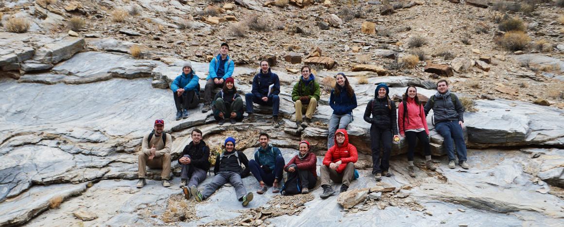 Students sitting in rock formations