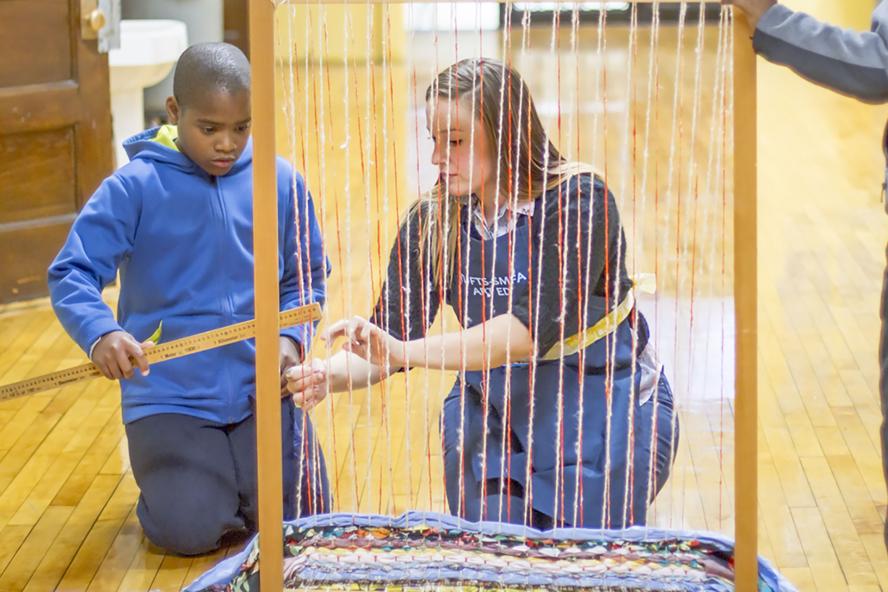 Adult student working with young student