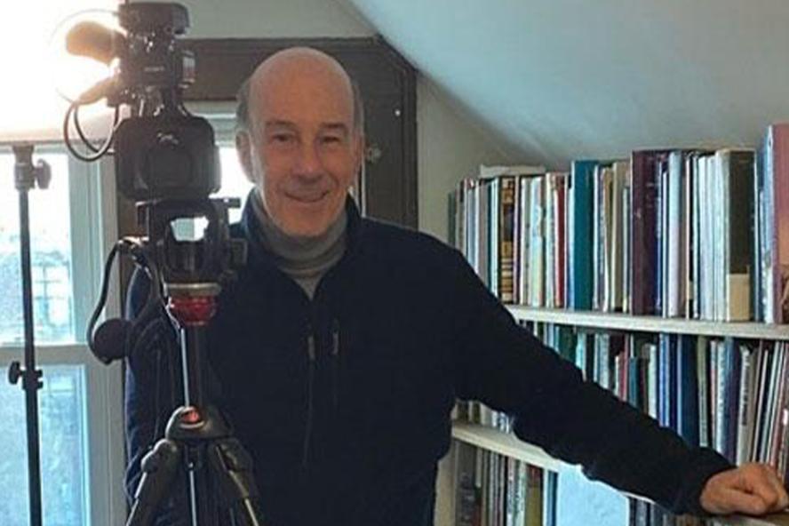 Phillip Gay standing next to his camera