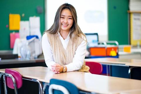 Stephnie Lin poses in classroom of West Somerville Neighborhood School