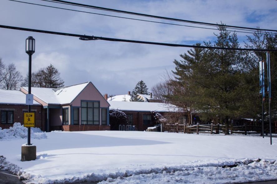 Home with a snowy front lawn