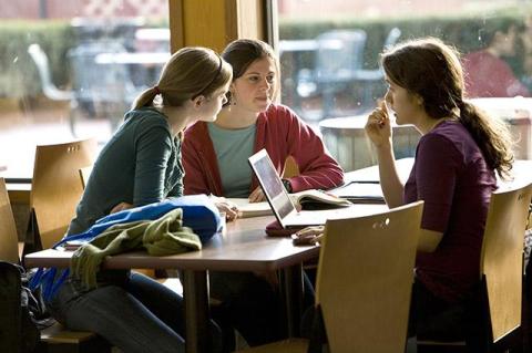 Students talking while sitting at a table