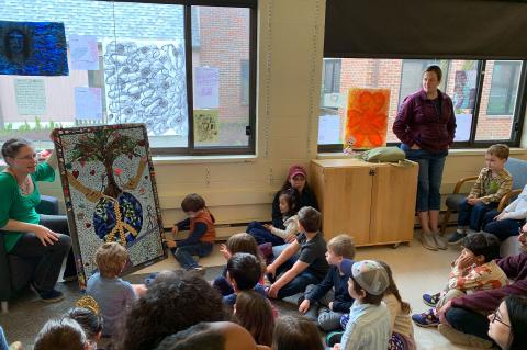 EPCS teacher showing and telling the final mosaic art work to students