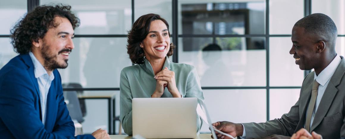 Three people speaking at a business meeting