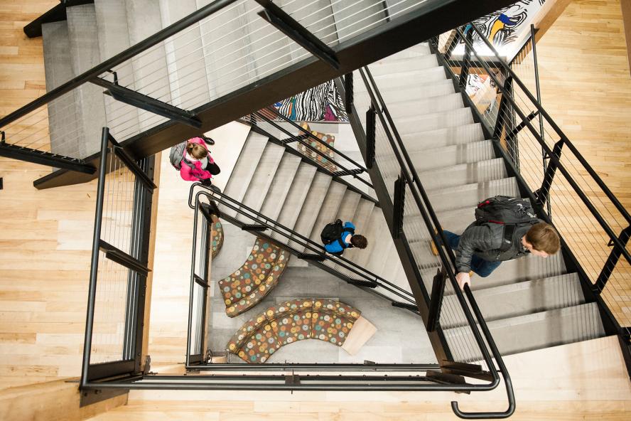 students walking down staircase top view