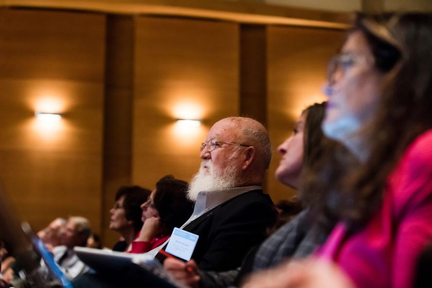 Professor Dennett in with others sitting in an auditorium