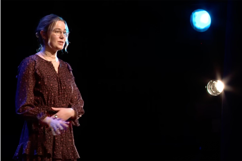 Audrey Ledbetter, onstage, speaking during her "TEDxTufts" talk