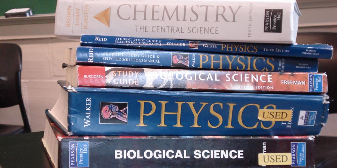 Stack of six science textbooks.