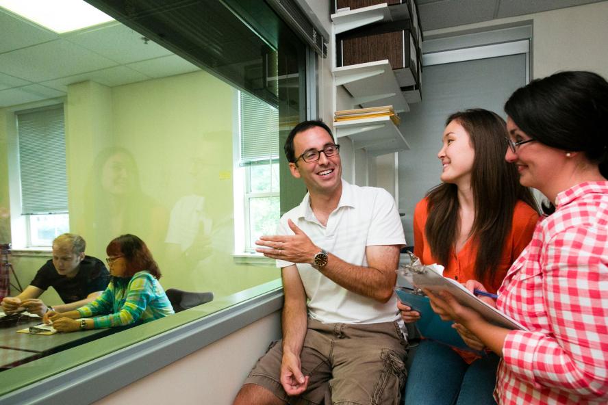 Professor Keith Sommers speaking with students in an observation booth