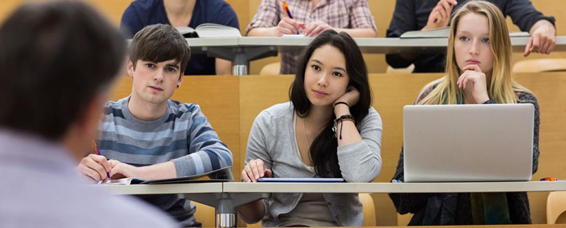 Three students in lecture hall