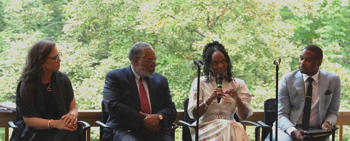 panel of 4 guests speaking at a forum