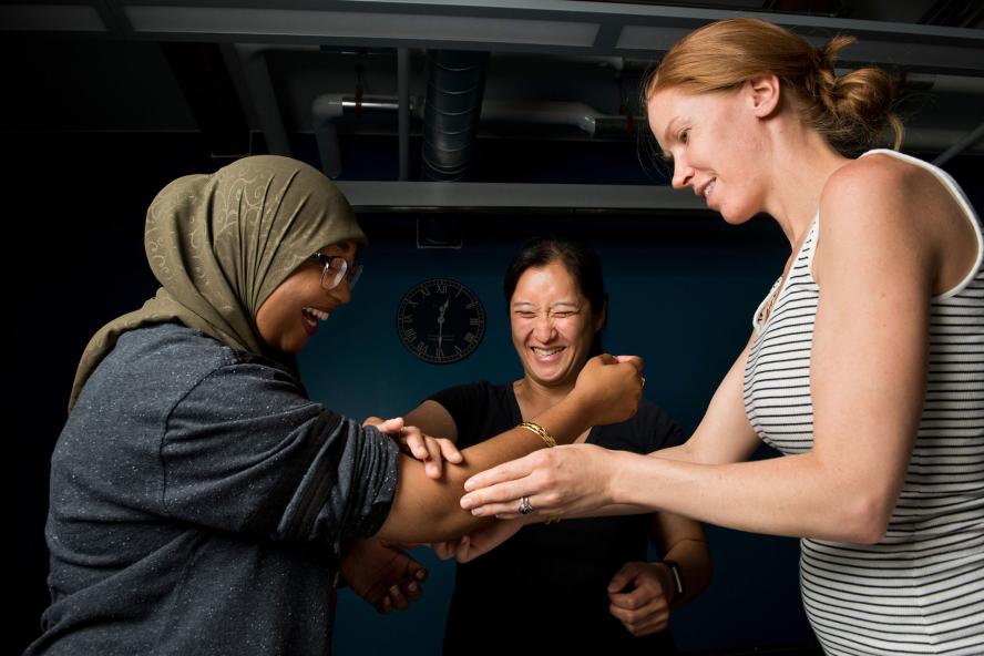 Occupational therapy students holding persons arm