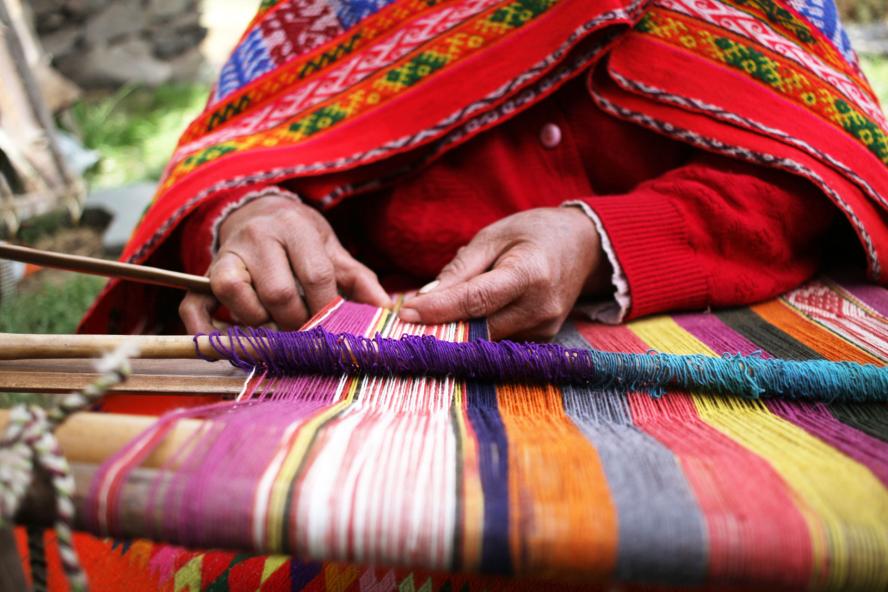 Woman weaving colored yarn