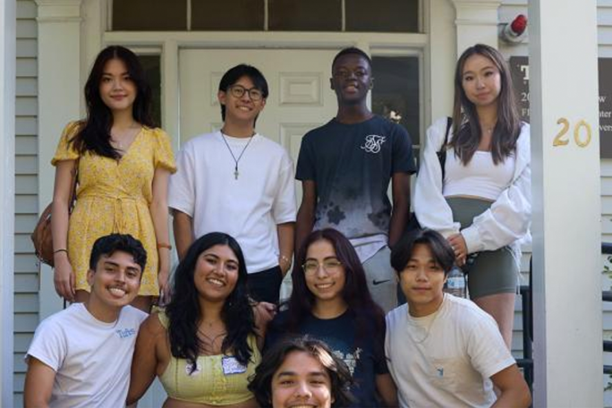 students pose on the front steps of the FIRST Center