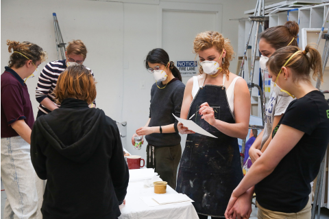 Brooke Stewart, MFA '18, shows students how to make paint with eggs during the Egg Tempera workshop.
