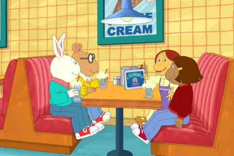 Characters from the kids TV show Arthur sitting in a booth
