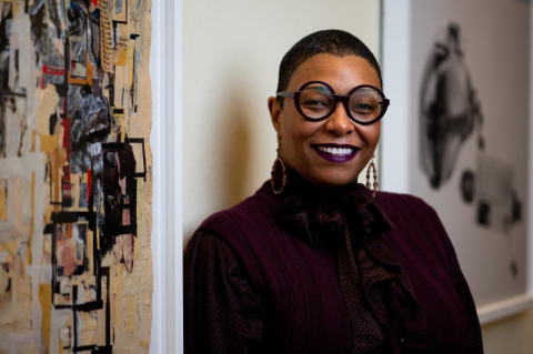 Kelli Morgan in the Tufts Art Galleries standing beside two paintings. Kelli Morgan’s career as a curator led her to establish the Anti-Racist Curatorial Practice certificate program at Tufts, to bring diversity to America’s art museums