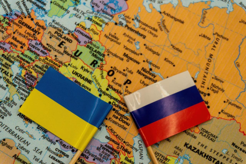 Map of Russia and Europe with Russian and Ukrainian flags. As the war in Ukraine enters its second year, a Tufts economist explains how Russia has coped with sanctions so far and what toll they could take over time
