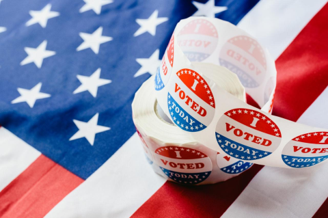 A roll of “I Voted Today” stickers on a U.S. flag. A new study finds that changes in state voting rules have very small effects in election outcomes 