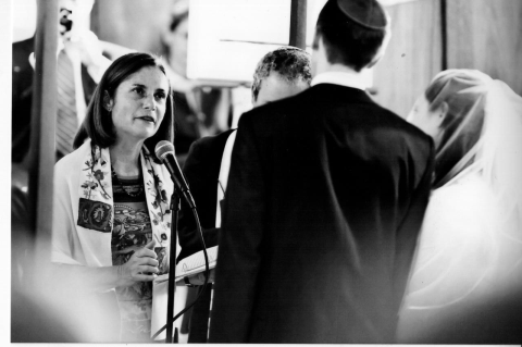 A black-and-white photo of Rabbi Sonia Saltzman officiating at a wedding