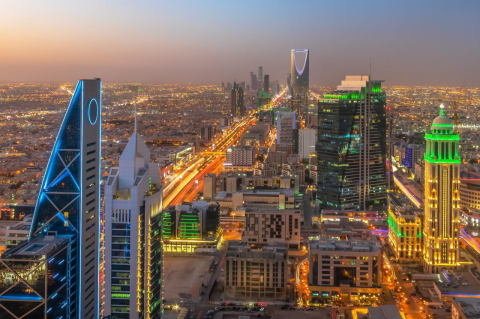 A view of downtown Riyadh, Saudi Araia as seen from above at night, with tall buildings and lights. A political scientist examines why democracy is so elusive in the oil-rich Middle East.