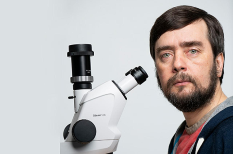 Professor Michael Levin next to a microscope