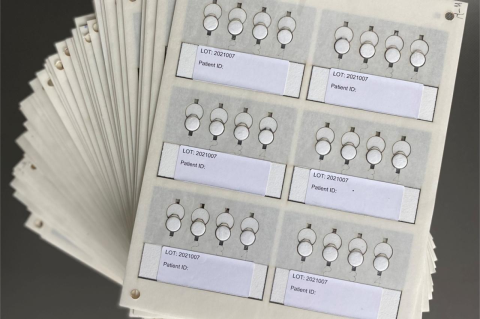 A number of paper cards with tabs for information and patient numbers. Tufts researchers collaborate with scientists in South Africa to trial a more precise medical device to measure HIV viral loads