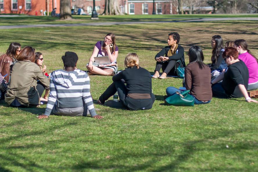 Women sitting in a circle talking on the Tufts campus